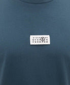 T-shirt Blu petrolio con etichetta "numeric" - YES SHOPT-shirtMM6 MAISON MARGIELASH0GC0071M20258-XXS3572075569871
